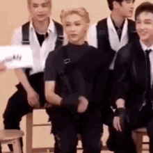 felix-skz-stray-kids-tuck-hair-shrug-debby-ryan-cross-legs.gif